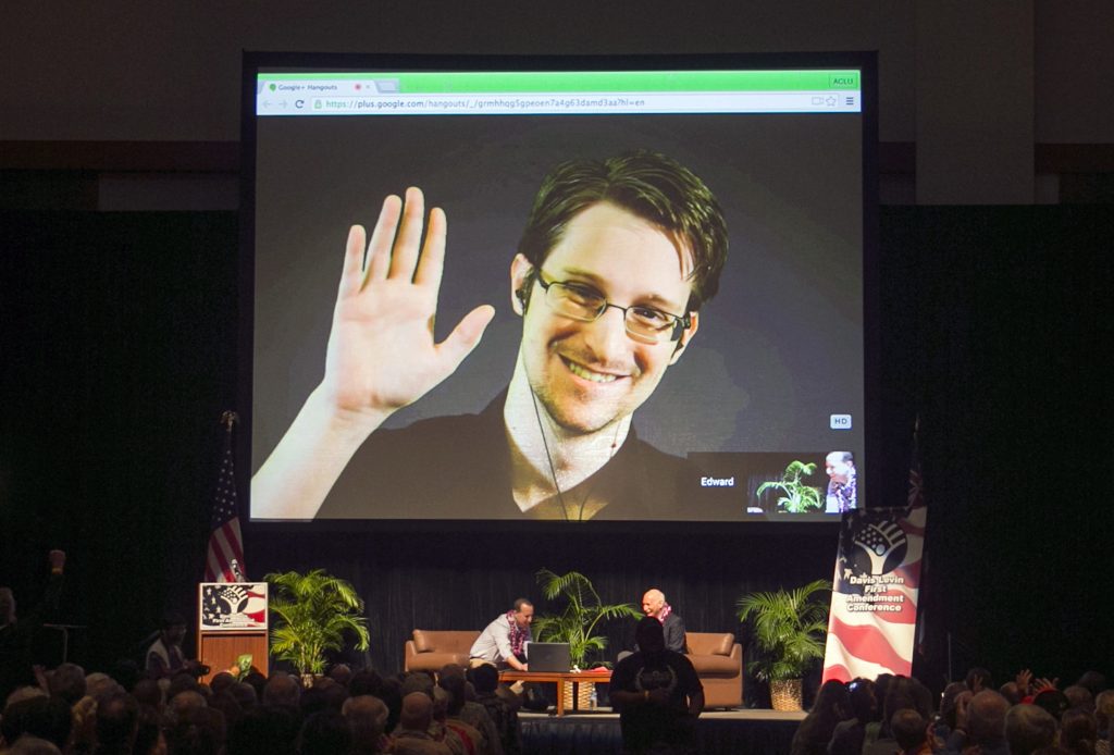 FILE - In this Feb. 14, 2015, file photo, Edward Snowden appears on a live video feed broadcast from Moscow at an event sponsored by ACLU Hawaii in Honolulu. Europe's human rights court is about to publish what could be a landmark ruling on the legality of mass surveillance. The case brought by civil liberties, human rights and journalism groups and campaigners challenges British surveillance and intelligence-sharing practices revealed by American whistleblower Edward Snowden. (AP Photo/Marco Garcia, File)
