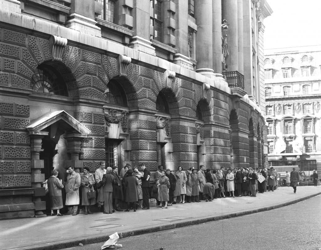 FILE - In this B/W file photo dated Oct. 27, 1960, a queue forms outside The Old Bailey Central Criminal Court, in London, for admission to the public gallery where the "Lady Chatterley's Lover" case is resuming. A paperback copy of "Lady Chatterley's Lover" by D.H. Lawrence's, used by the judge in the book’s landmark U.K. obscenity trial is expected to sell at auction for up to 15,000 pounds ($20,000) by Sotheby's on Oct. 30, 2018. (AP Photo/File)