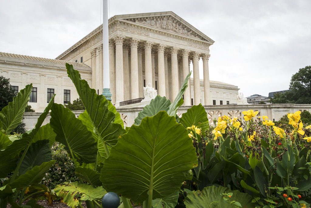 In this Sept. 21, 2018, photo, the Supreme Court is seen in Washington. On Monday, the court will begin its new term with the crack of the marshal’s gavel and not a camera in sight. (AP Photo/J. Scott Applewhite)