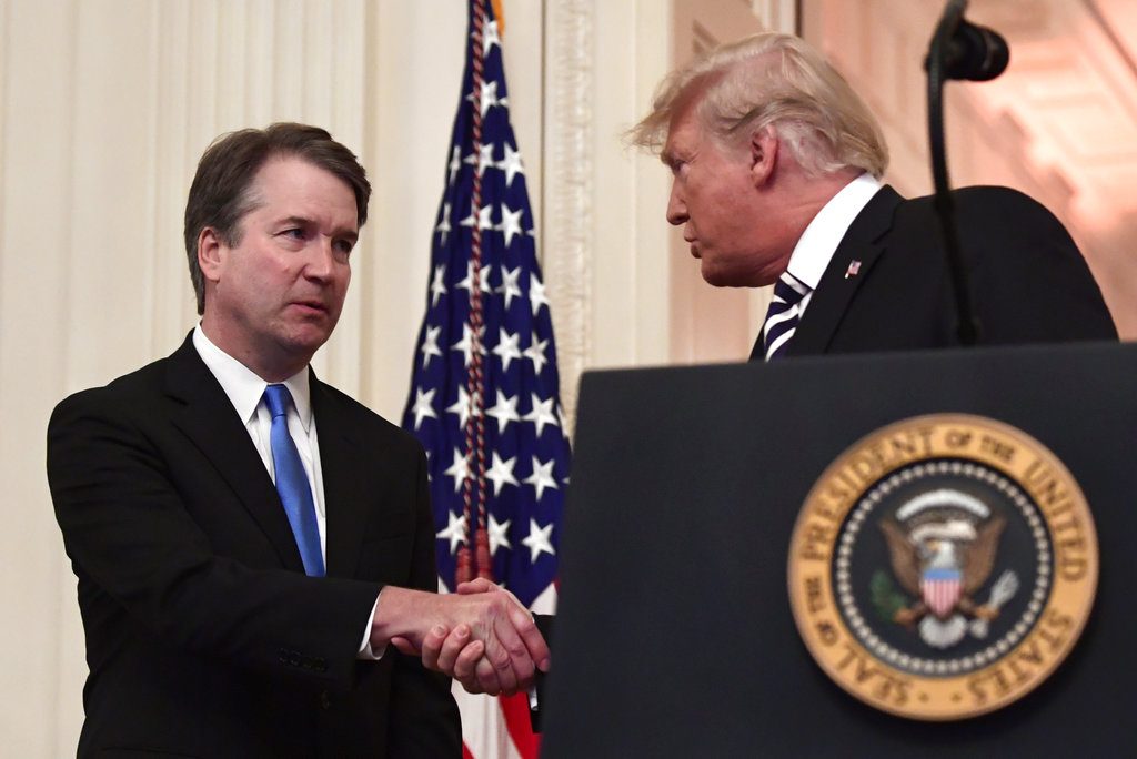President Donald Trump, right, shakes hands with Supreme Court Justice Brett Kavanaugh, left, before a ceremonial swearing in in the East Room of the White House in Washington, Monday, Oct. 8, 2018. (AP Photo/Susan Walsh)