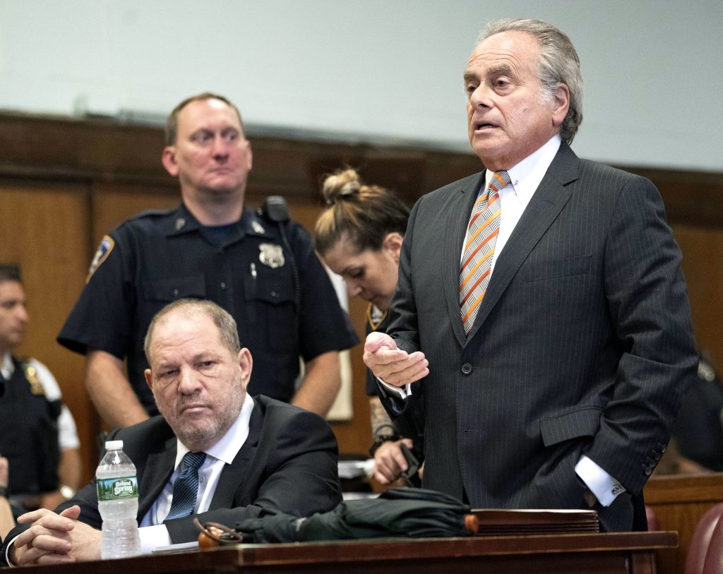 Harvey Weinstein, left, looks on while his attorney Benjamin Brafman speaks during a hearing in New York, Thursday, Oct. 11, 2018. Manhattan's district attorney dropped part of the criminal sexual assault case against Weinstein on Thursday after evidence emerged that cast doubt on the account one of his three accusers provided to the grand jury. (Steven Hirsch /New York Post via AP, Pool)