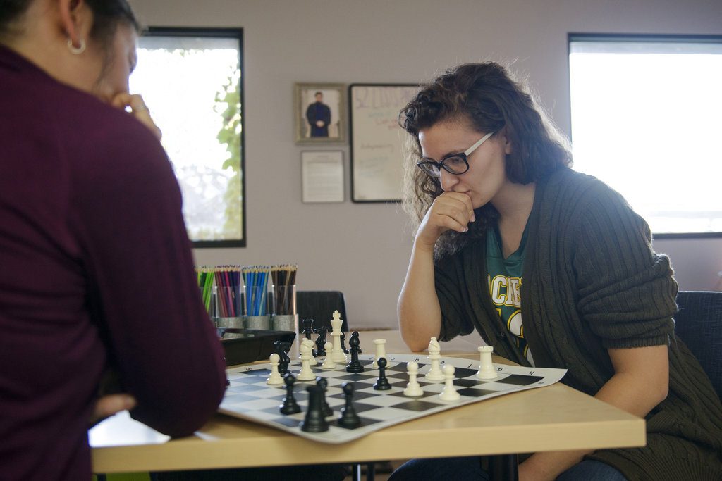 In this Sept. 12, 2018, photo, law students Jessica Szuminski and Makenzie Krause play a game of chess in Mondale Hall of University of Minnesota in Minneapolis. The therapy room that they are in offers law students the chance to unwind without the distractions of technology or homework. (Jack Rodgers/The Minnesota Daily via AP)
