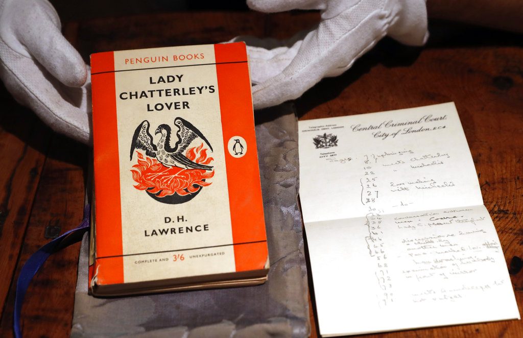 FILE - In this Friday, Oct. 26, 2018 file photo, a copy of D.H Lawrence's book "Lady Chatterley's Lover" that was the judge's personal version used in the infamous 1960 Chatterley trial, on view in Sotheby's auction house in London. The copy used by the judge in the U.K. obscenity trial of the novel's publisher has sold at auction for 56,250 pounds ($72,000), more than three times its pre-sale estimate. The tattered Penguin paperback, along with a damask bag designed to stop photographers snapping the judge with the scandalous tome, sold to an anonymous bidder at Sotheby's in London on Tuesday Oct. 31, 2018. (AP Photo/Alastair Grant, File)