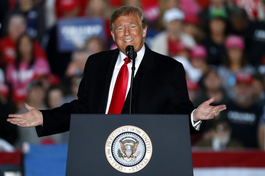 In this Oct. 27, 2018, photo, President Donald Trump speaks during a rally at Southern Illinois Airport in Murphysboro, Ill. Eager to focus voters on immigration in the lead-up to the midterm elections, Trump on Monday escalated his threats against a migrant caravan trudging slowly toward the U.S. border as the Pentagon prepared to deploy thousands of U.S. troops to support the border patrol. (AP Photo/Jeff Roberson)