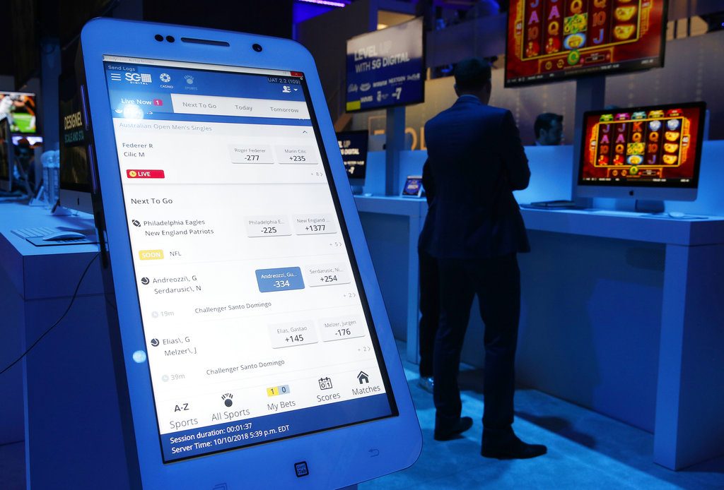 The OpenBet mobile sports betting app is on display at the Scientific Games booth during the Global Gaming Expo, Wednesday, Oct. 10, 2018, in Las Vegas. (AP Photo/John Locher)