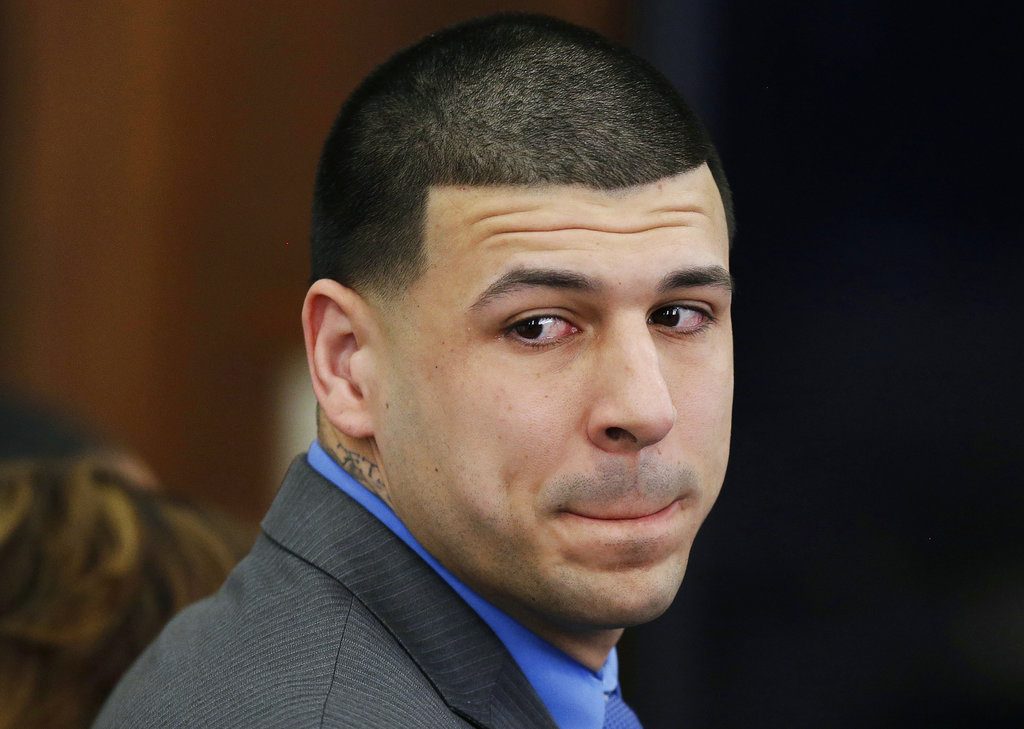 FILE - In this Friday, April 14, 2017, file photo, former New England Patriots tight end Aaron Hernandez turns to look in the direction of the jury as he reacts to his double murder acquittal in the 2012 deaths of Daniel de Abreu and Safiro Furtado, at Suffolk Superior Court in Boston. On Thursday, Nov. 8, 2018, Massachusetts' Supreme Judicial Court will consider whether the state should get rid of the centuries-old legal principle that erased Hernandez's murder conviction after he killed himself in prison. (AP Photo/Stephan Savoia, Pool, File)