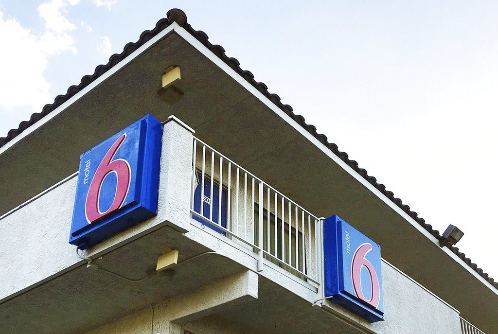 FILE - This Sept. 14, 2017, file photo shows a Motel 6 in Phoenix. The Motel 6 chain has agreed in a proposed settlement to pay up to $7.6 million to guests who say the company's employees shared their private information with immigration officials. (AP Photo/Anita Snow, File)