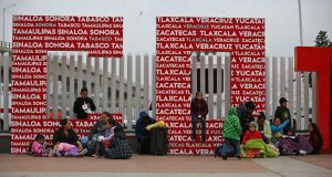 Migrants wait for a chance to request U.S. asylum, alongside the El Chaparral pedestrian border crossing in Tijuana, Mexico, Friday, Dec. 21, 2018. (AP Photo/Moises Castillo)