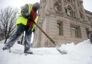 Robert Delgado, with the Milwaukee Public Library, shovels in front of the Milwaukee Public Library in Milwaukee on Monday, Jan. 28, 2019. Heavy snow and gusting winds created blizzard-like conditions Monday across parts of the Midwest, prompting officials to close hundreds of schools, courthouses and businesses as forecasters warn that dangerously cold weather is right behind the snowstorm. (Mike De Sisti/Milwaukee Journal-Sentinel via AP)