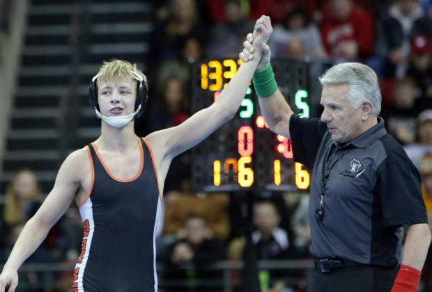 Hayden Halter, then a freshman wrestler for Burlington High School, has his hand raised in February 2018 by a referee after his victory en route to the 106-pound state championship at the Kohl Center in Madison. Now a sophomore at Waterford Union High School, Halter was faced with a suspension after receiving two unsportsmanlike penalties during the Southern Lakes Conference championship match on Feb. 2. A Wisconsin judge overturned his suspension after his parents took legal action, worrying referees and the state's athletic association that officiating decisions could be undermined by courts. (Amber Arnold/The Journal Times via AP)
