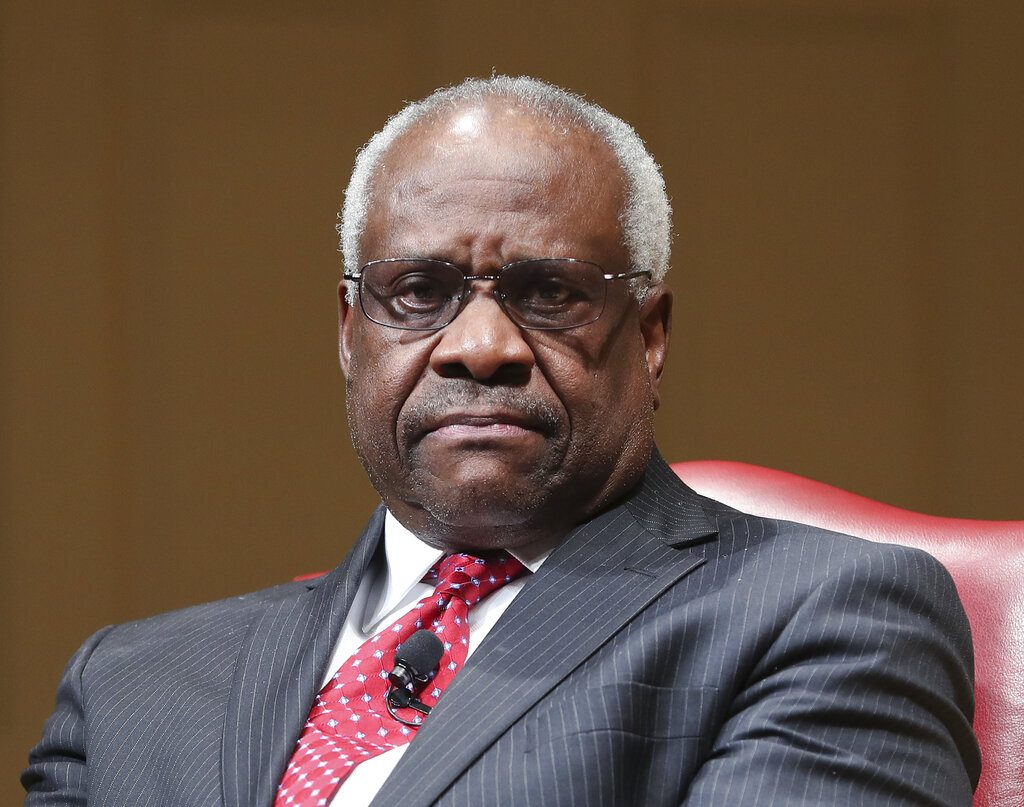 FILE - In this Feb. 15, 2018, file photo, Supreme Court Associate Justice Clarence Thomas sits as he is introduced during an event at the Library of Congress in Washington. Thomas is asking his first questions at Supreme Court arguments in more than three years. Arguments were almost over Wednesday in a case about racial discrimination in the South when the court’s only African-American member and lone Southerner piped up.(AP Photo/Pablo Martinez Monsivais, File)