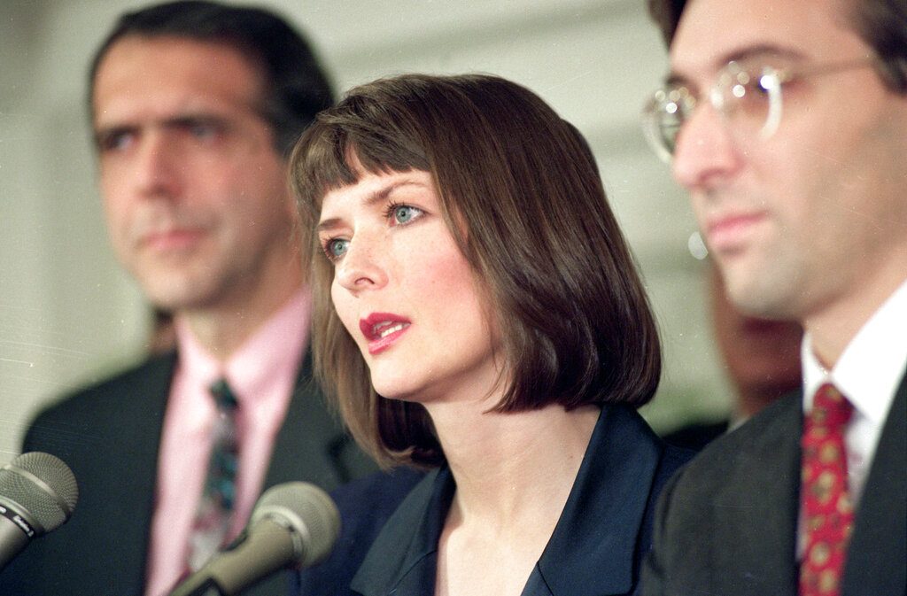 FILE - In this Dec. 10, 1992 file photo, flanked by her attorneys Frank Morocco, left, and Sheldon T. Zenner, right, Lawrencia Bembenek answers questions at a new conference in Chicago, Ill. The attorney for Wisconsin's famous runaway convict and convicted murderer Laurie "Bambi" Bembenek is asking Gov. Tony Evers for a pardon. Bembenek insisted up until her death in 2010 that she did not kill the ex-wife of her husband in 1982. Her attorney filed a pardon request with Evers earlier this year. Bembenek, a former Milwaukee Police officer who escaped from prison after she was convicted of murder in a wild criminal saga that later became a TV miniseries. (AP Photo/Mark Elias, File)