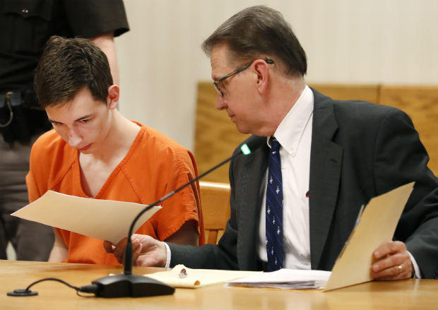 Alexander M. Kraus, 17, is handed documents by his attorney, Gregory Petit, during his initial appearance on Tuesday in the Outagamie County Circuit Court in Appleton. Kraus was charged with two counts of first-degree intentional homicide in the deaths of his grandparents, 74-year-old Dennis Kraus and 73-year-old Letha Kraus. Each charge carries a life sentence. (Danny Damiani/The Post-Crescent via AP)