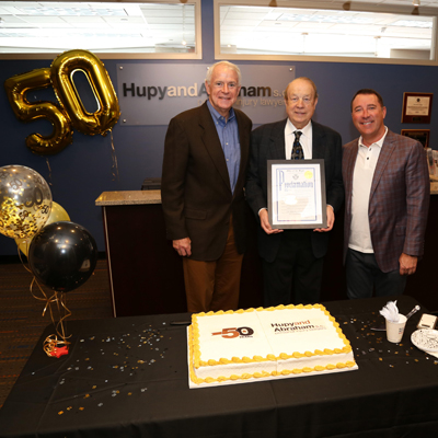 Milwaukee Mayor Barrett declares April 15 as Hupy and Abraham Day during the law firm’s 50th anniversary celebration in downtown Milwaukee alongside Michael Hupy and Jason Abraham. (PHOTO COURTESY OF HUPY AND ABRAHAM)