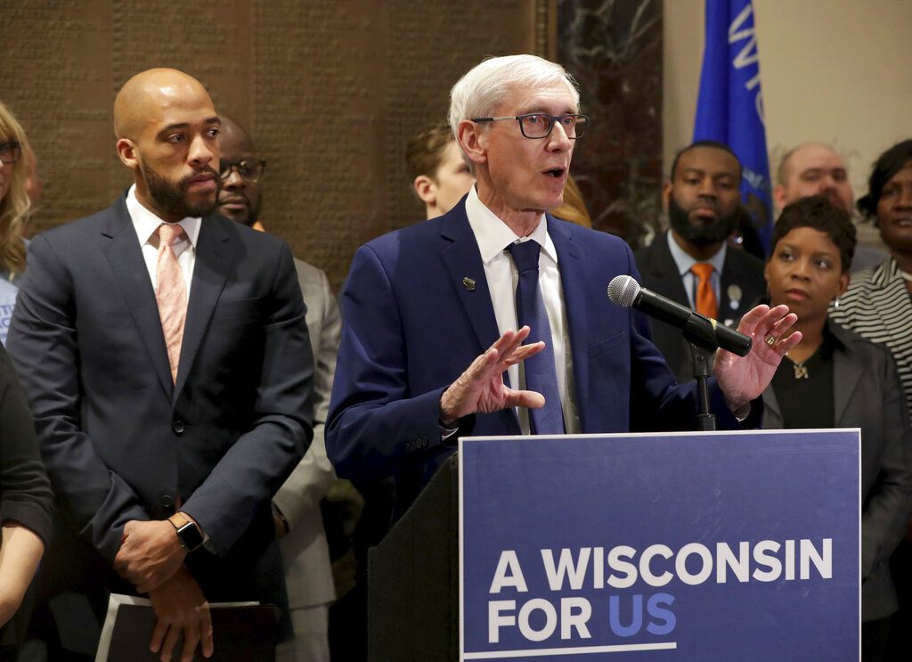 Gov. Tony Evers speaks at a news conference regarding Medicaid expansion as Lt. Gov. Mandela Barnes, left, stands next to him, at Milwaukee City Hall, Thursday, May 2, 2019. (Mike De Sisti/Milwaukee Journal-Sentinel via AP)