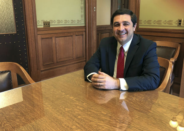 Attorney General Josh Kaul sits in his Capitol office conference room in Madison. During his four months in office, Kaul has shifted the state Justice Department away from his Republican predecessor's conservative stances by withdrawing the state from or changing its positions on a host of lawsuits. (AP Photo/Todd Richmond)
