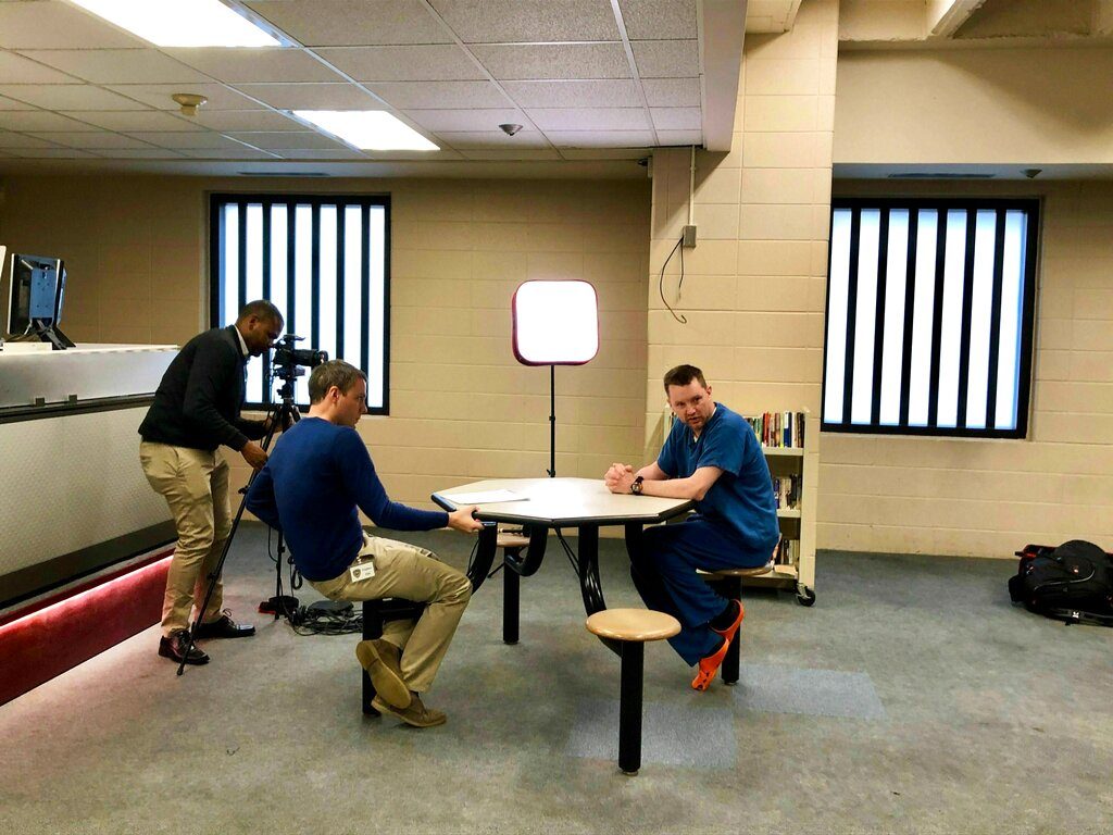 National Association of Counties Communication Director Paul Guequierre, center, interviews Dane County Jail inmate Christopher Beierle at the Dane County Jail in Madison on Monday, May 6, 2019. (Abigail Becker/The Capital Times via AP)