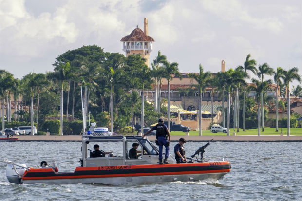 A U.S. Coast Guard patrol boat passes President Donald Trump's Mar-a-Lago estate in Palm Beach, Florida, on Nov. 22. The University of Wisconsin student Mark Lindblom has pleaded guilty to sneaking into Mar-a-Lago last fall during one of President Donald Trump’s visits to his Florida club. Lindblom apologized on Tuesday and received a year’s probation after prosecutors agreed he meant no harm. (AP Photo/J. David Ake, File)