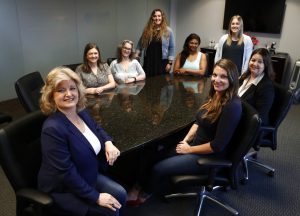In this Tuesday, May 14, 2019, photo, business owner Meloney Perry, left front, poses for a photo with members of her staff, Karla Roush, from left rear, Lisa Amerson, Michelle Smith, Lauren Pickett, Samantha Doherty, Stacy Thompson and Brooke Bailey, right front, at her law firm in Dallas. Small business owners are making their company culture a bigger priority as they respond to the dramatically different expectations of a younger work force and a low unemployment rate that makes it harder to find staffers. (AP Photo/Tony Gutierrez)