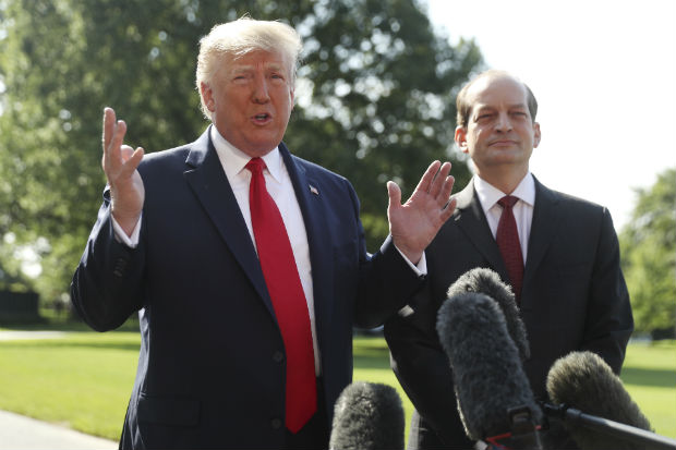 President Donald Trump speaks to members of the media with Secretary of Labor Alex Acosta on the South Lawn of the White House on July 12 before Trump boards Marine One for a short trip to Andrews Air Force Base, Maryland. and then on to Wisconsin. (AP Photo/Andrew Harnik)