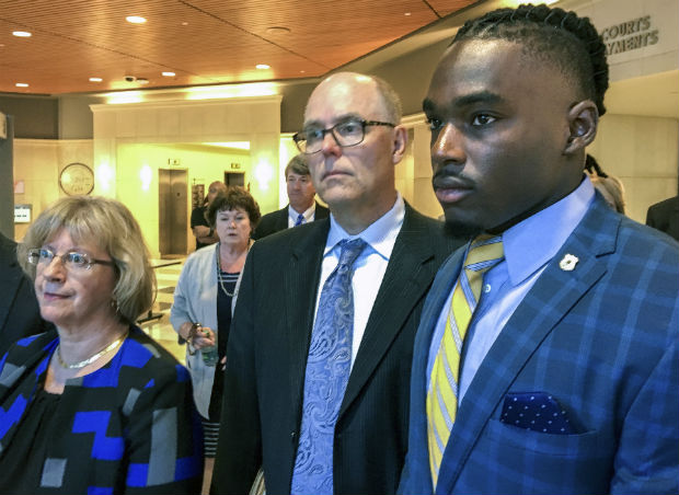 The University of Wisconsin wide receiver Quintez Cephus, right, walks with his attorneys Kathleen Stalling, left, and Stephen Meyer after appearing in court in Madison on Aug. 23. The trial of Cephus has begun with a woman testifying that Cephus raped her in his apartment. (Ed Treleven/Wisconsin State Journal via AP, File)