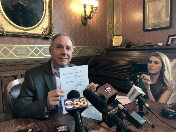 Assembly Speaker Robin Vos, left, displays his signature on the state budget on Friday in his state Capitol office in Madison. The budget now goes to Gov. Tony Evers, who has until July 5 to sign it, veto it or use his partial veto powers to revise it. (AP Photo/Todd Richmond)