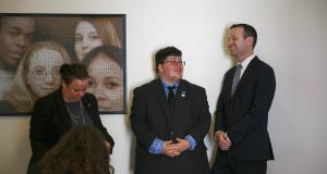 Gavin Grimm, center, a young man who has become a national face for transgender student, speaks with Josh Block, ACLU senior staff attorney before the start of a press conference, Tuesday morning, July 23, 2019, held by The ACLU and the ACLU of Virginia at Slover Library in Norfolk, Va. Grimm, now 20, transitioned from girl to boy before his sophomore year and sued after the Gloucester County School Board banned him from using boys' bathrooms. (Kristen Zeis/The Daily Press via AP)