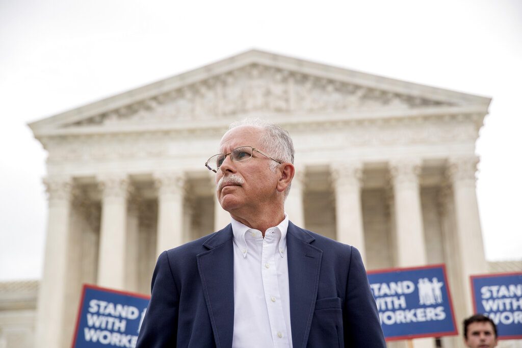 FILE - In this Wednesday, June 27, 2018, file photo, plaintiff Mark Janus stands outside the Supreme Court after the court rules in a setback for organized labor that states can't force government workers to pay union fees, in Washington. Union membership among public employees has fallen only slightly in the nation’s most unionized states since the Supreme Court ruled in 2018 that government workers no longer could be required to pay union fees, according to an analysis of federal data conducted for The Associated Press. (AP Photo/Andrew Harnik, File)