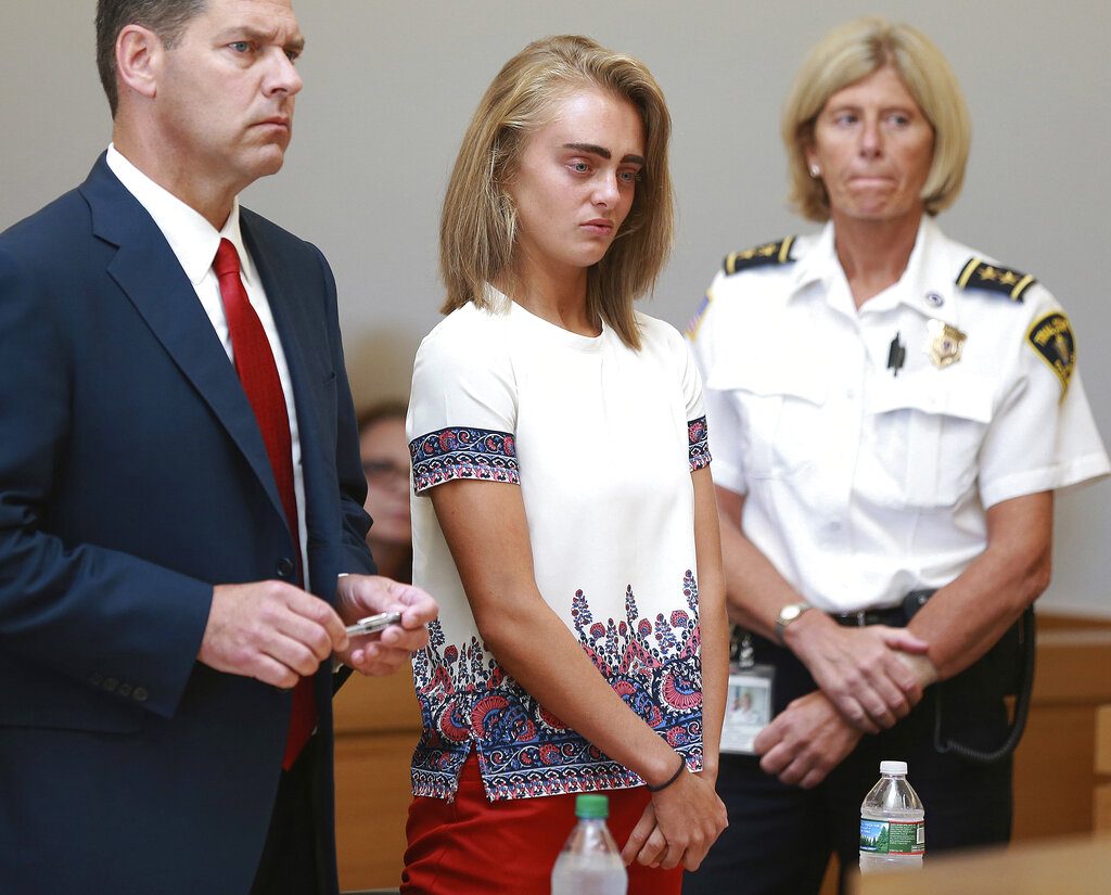 FILE -- In this Aug. 3, 2017 file photo Michelle Carter, center, listens to her sentencing for involuntary manslaughter for encouraging 18-year-old Conrad Roy III to kill himself in July of 2014. Her defense attorney Joseph Cataldo stands at left. Lawyers for Carter have appealed her involuntary manslaughter conviction to the U.S. Supreme Court. Carter's attorneys told the high court in a petition filed Monday, July 8, 2019 that her conviction, based on her "words alone," violated her First Amendment right to free speech. (Matt West/The Boston Herald via AP, Pool, File)