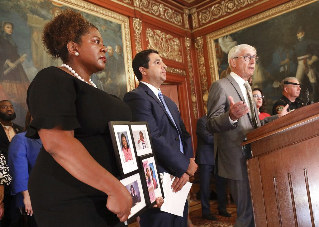 Wisconsin Governor Tony Evers speaks during a press conference announcing a bill that would expand background checks to most private gun sales in the state at the Wisconsin State Capitol in Madison, Wis. Thursday, Aug. 15, 2019. Others speakers at the event included Sen. LaTonya Johnson, D-Milwaukee, left, who delivered remarks about constituents in her district who have been affected by gun violence, and Wisconsin Attorney General Josh Kaul, center. (John Hart/Wisconsin State Journal via AP)
