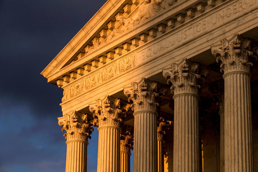 FILE - In this Oct. 10, 2017, file photo, the Supreme Court in Washington is seen at sunset. The Supreme Court is allowing nationwide enforcement of a new Trump administration rule that prevents most Central American immigrants from seeking asylum in the United States. The justices’ order late Wednesday, Sept. 11, temporarily undoes a lower court ruling that had blocked the new asylum policy in some states along the southern border. (AP Photo/J. Scott Applewhite, File)