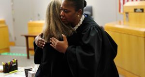 Judge Tammy Kemp hugs former Dallas police officer Amber Guyger