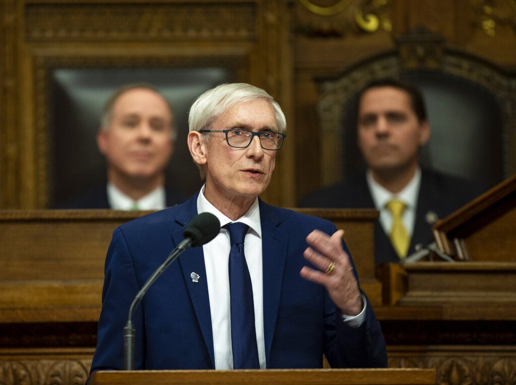 FILE - In this Jan. 22, 2019 file photo, Wisconsin Gov. Tony Evers addresses a joint session of the Legislature in the Assembly chambers during the Governor's State of the State speech at the state Capitol, in Madison, Wis. Behind Evers is Assembly Speaker Robin Vos, R-Rochester, left, and Senate President Roger Roth, R-Appleton. Evers tried for months for the Legislature to take up gun control bills to no avail. So he recently called a special session to force them to convene on the issue. (AP Photo/Andy Manis, File)