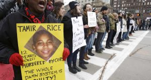 FILE - In this Nov. 25, 2014, file photo, demonstrators block Public Square in Cleveland during a protest over the police shooting of 12-year-old Tamir Rice. A wave of police killings of young black men in 2014 prompted 24 states to quickly pass some type of law enforcement reform, but many declined to address the most glaring issue: police use of force. Six years later, only about a third of states have passed laws on the question. (AP Photo/Tony Dejak, File)