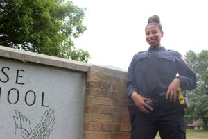 Kiara Riser, 21, stands on Saturday outside her alma mater Case High School in Racine,. She is in the police academy at Gateway Technical College and has already been hired by the Caledonia Police Department, where she will become the first-ever Black female officer hired by the department. (Adam Rogan/The Journal Times via AP)