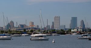 This Aug. 13, 2020 photo shows the skyline of downtown Milwaukee, the location of a scaled down Democratic National Convention. About 50,000 visitors were expect to inject about $250 million into the economy of the key presidential battleground state. But now, thanks to the ongoing coronavirus pandemic, the convention is nearly entirely online, with all of the major speakers, including presumptive nominee Joe Biden, skipping the trip to Milwaukee. It would have been the first time Milwaukee, a city of 1.6 million, hosted a presidential nominating convention. (AP Photo/Carrie Antlfinger)
