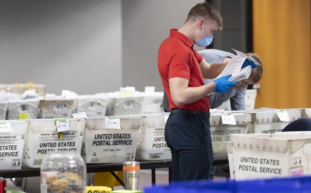 A Milwaukee Election Commission worker processes and sorts absentee ballots on April 8 for Wisconsin's primary election, in downtown Milwaukee,. The conservative-controlled Wisconsin Supreme Court has ordered no absentee ballots to be mailed until it gives the go-ahead or makes any future ruling about who should be on the ballot in the battleground state. (Mark Hoffman/Milwaukee Journal-Sentinel via AP, File)