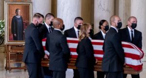 The flag-draped casket of Justice Ruth Bader Ginsburg, carried by Supreme Court police officers, arrives in the Great Hall at the Supreme Court in Washington, on Wednesday. Ginsburg, 87, died of cancer on Sept. 18. (AP Photo/Andrew Harnik, Pool)