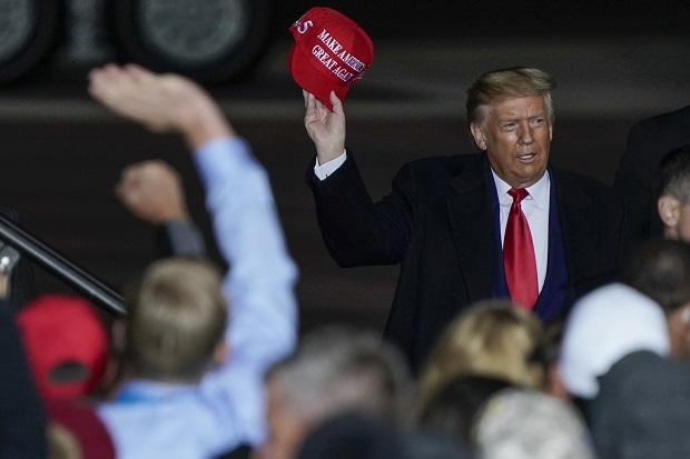 President Donald Trump throws a hat to the crowd at his campaign rally at the Central Wisconsin Airport on Sept. 17, in Mosinee. (AP Photo/Morry Gash)