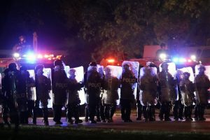 Police in riot gear line up on Oct. 9 in Wauwatosa. On Wednesday, District Attorney John Chisholm refused to issue charges against Wauwatosa Police Officer Joseph Mensah for the Feb. 2 fatal shooting of 17-year-old Alvin Cole at Mayfair Mall. (AP Photo/Morry Gash)
