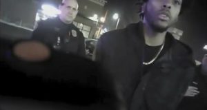 Police body-camera footage from Jan. 26,2018, shows the NBA Bucks guard Sterling Brown talking to arresting police officers after being shot by a stun gun in a Walgreens parking lot in Milwaukee. The Milwaukee city attorney is recommending a revised offer to settle a lawsuit brought by Milwaukee Bucks’ guard Sterling Brown, who was taken to the ground, shocked with a Taser and arrested during an encounter with police in 2018. City Attorney Tearman Spencer is recommending a $750,000 payment and an admission that Brown's constitutional rights were violated during the arrest. (Milwaukee Police Department via AP, File)