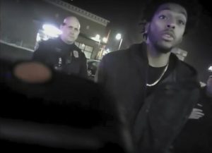 Police body-camera footage from Jan. 26,2018, shows the NBA Bucks guard Sterling Brown talking to arresting police officers after being shot by a stun gun in a Walgreens parking lot in Milwaukee. The Milwaukee city attorney is recommending a revised offer to settle a lawsuit brought by Milwaukee Bucks’ guard Sterling Brown, who was taken to the ground, shocked with a Taser and arrested during an encounter with police in 2018. City Attorney Tearman Spencer is recommending a $750,000 payment and an admission that Brown's constitutional rights were violated during the arrest. (Milwaukee Police Department via AP, File)