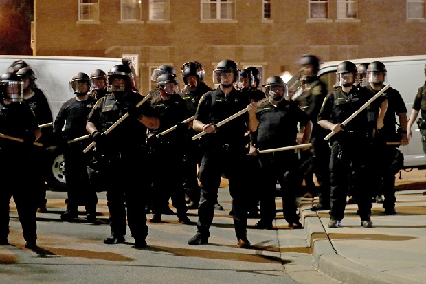 Police in riot gear stand guard on August 23 in Kenosha. (Mike De Sisti/Milwaukee Journal-Sentinel via AP, File)