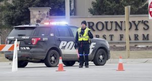 Police respond to an attack at the Roundy's distribution warehouse in Oconomowoc, about 30 miles west of Milwaukee on Wednesday. A worker shot and killed two colleagues at the supermarket distribution center before crashing his vehicle during a police pursuit and then killing himself, a union official and police said. (Mike De Sisti/Milwaukee Journal-Sentinel via AP)
