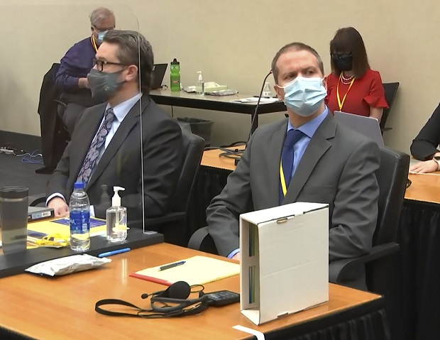 In this image from video, defense attorney Eric Nelson, left, and former Minneapolis police officer Derek Chauvin listen as Hennepin County Judge Peter Cahill presides over pre-trial motions before opening statements on Monday in the trial of Chauvin for the death of George Floyd. (Court TV via AP, Pool)