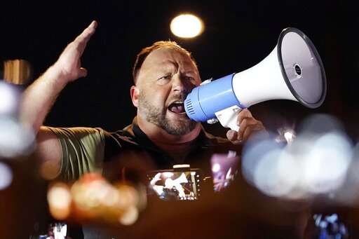 FILE - In this Nov. 5, 2020 file photo, radio host Alex Jones rallies pro Trump supporters outside the Maricopa County Recorder's Office, in Phoenix. The U.S. Supreme Court on Monday, April 5, 2021 declined to hear an appeal by the Infowars host and conspiracy theorist, who was fighting a Connecticut court sanction in a defamation lawsuit brought by relatives of some of the victims of the Sandy Hook Elementary School shooting. (AP Photo/Matt York, File)