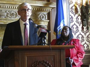 Wisconsin Gov. Tony Evers speaks on May 20, 2019, in Madison during a news conference as Democratic state Rep. Sheila Stubbs listens. (AP Photo/Scott Bauer, File)