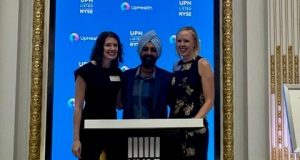 Husch Blackwell attorney Robin Lehninger; Dr. Chirinjeev Kathuria, chairman and founder of UpHealth; and Husch Blackwell partner Kate Bechen pose for a photo after ringing the opening bell at the New York Stock Exchange on Monday.