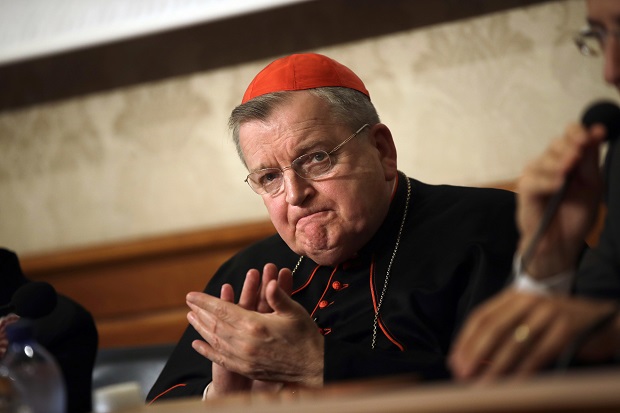 Cardinal Raymond Burke applauds on Sept. 6, 2018, during a press conference at the Italian Senate in Rome. Cardinal Burke, one of the Catholic Church's most outspoken conservatives and a vaccine skeptic, said he has COVID-19 and his staff said he is breathing through a ventilator. (AP Photo/Alessandra Tarantino, File)
