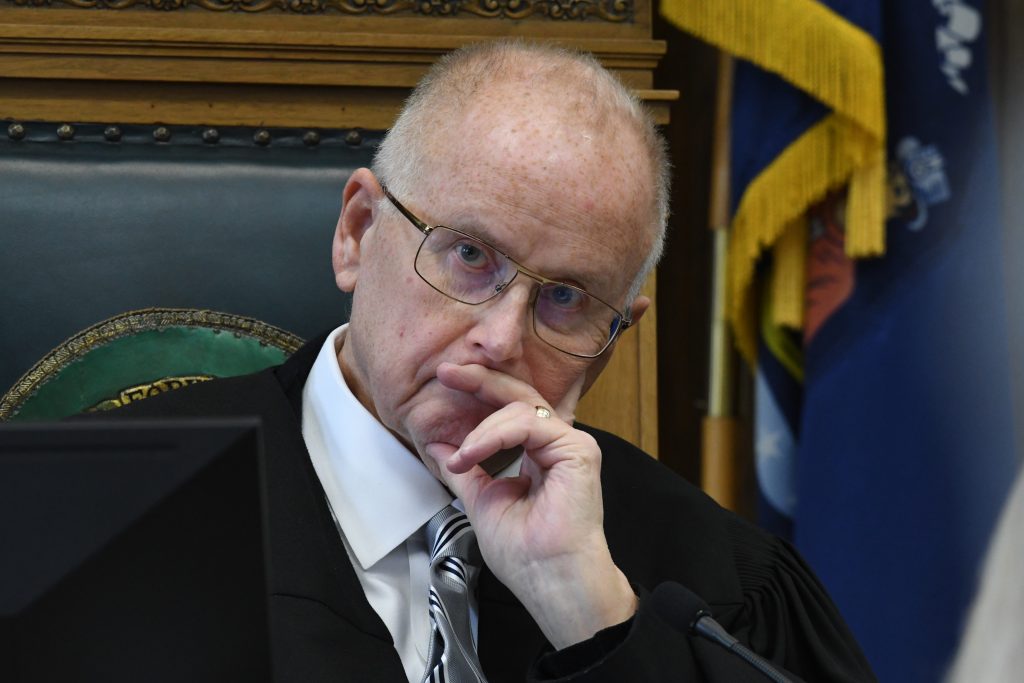 Circuit Court Judge Bruce E. Schroeder listens during the pretrial hearing of Kyle Rittenhouse in Kenosha Circuit Court, Monday, Oct. 25, 2021, in Kenosha, Wis. Rittenhouse shot three people, killing two of them, during a protest against police brutality in Kenosha in August 2020. (Mark Hertzberg/Pool Photo via AP)